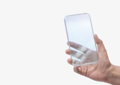 Hand holding transparent smartphone futuristic technology concep