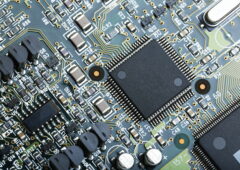 Closeup of electronic circuit board with CPU microchip electronic components background