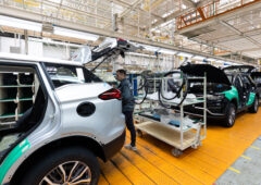 Minsk, Belarus   Dec 15, 2021: Car bodies are on assembly line. Factory for production of cars. Modern automotive industry. Electric car factory, conveyor